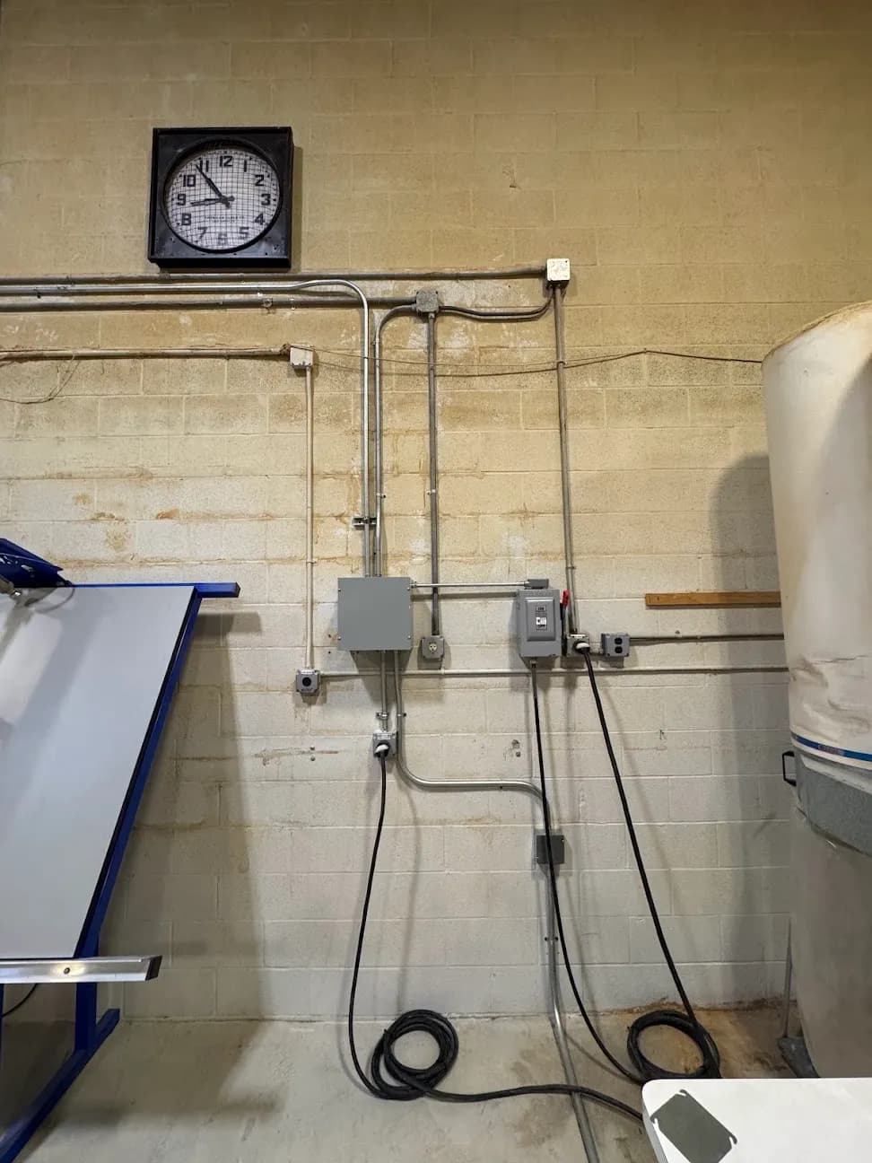 A conduit run leading to a wall-mounted disconnect box