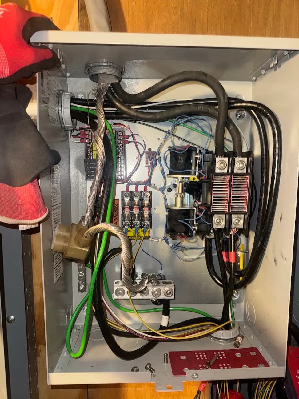 The interior of an opened electrical disconnect showing lugs, terminals, and wiring